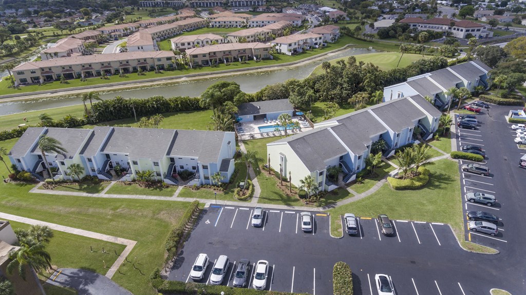 A parking lot with cars and a building in the background.